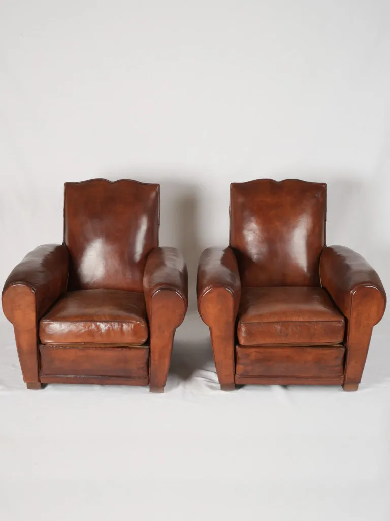 Pair of antique French leather club chairs - moustache back