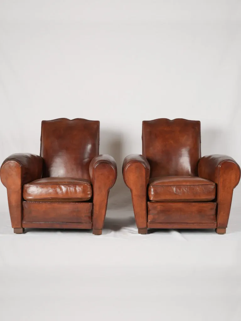 Pair of antique French leather club chairs - moustache back