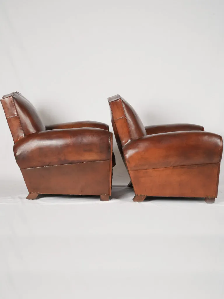 Pair of antique French leather club chairs - moustache back