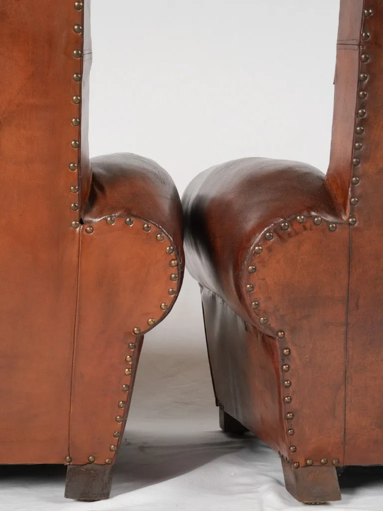 Pair of antique French leather club chairs - moustache back