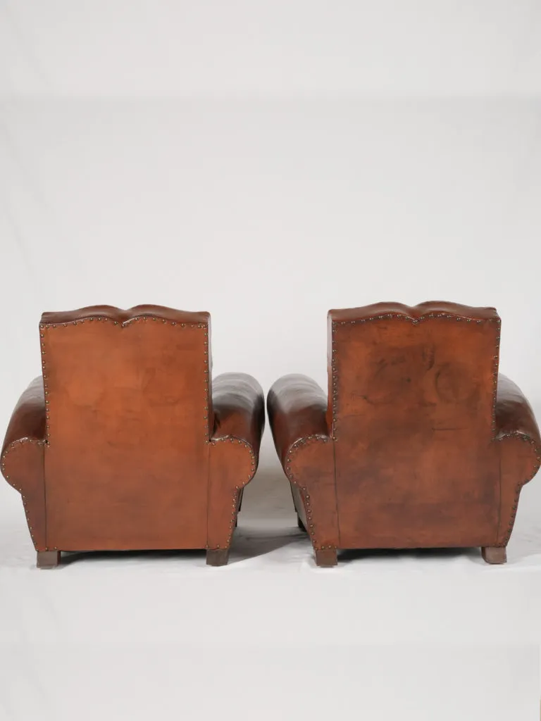 Pair of antique French leather club chairs - moustache back