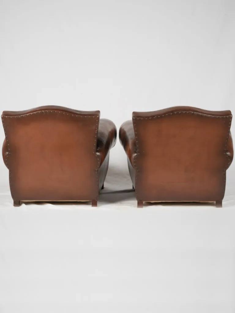 Pair of restored antique French leather club chairs